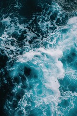 Fototapeta premium Aerial view of deep blue sea with frothy waves