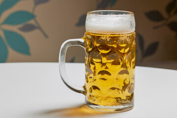 a pint full of beer on a table in the kitchen