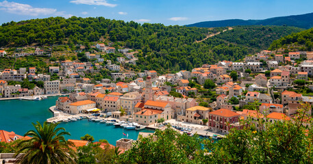 Fototapeta na wymiar Pučišća village panorama on Brac island, Croatia. Mediterranean holiday destination with picturesque historic harbor fjord in summer with yachts, sailing boats. Idyllic atmosphere in adriatic sea.