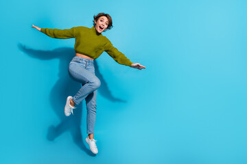 Fototapeta na wymiar Full length photo of cheerful glad girl wear stylish clothes rejoice summer vacation empty space isolated on cyan color background