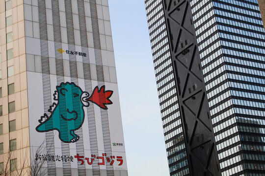 TOKYO, JAPAN - February 7, 2019: Picture of Chibi Gojira (Little Godzilla, designed by Chiharu Sakazaki) on Shinjuku Sumitomo Building. Next to it is the Mitsu Building.