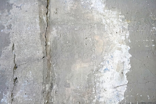 Real closeup photography texture of grey and chipped white painted concrete structure floor or wall useful as industrial urban background or overlay