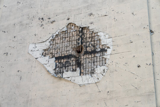 A bullet hole in a building wall