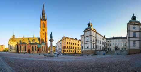Obraz premium The Riddarholmen Church in Stockholm, Sweden. Cityscape of Stockholm, Sweden. Evening time and soft sunlight. A walk through the city. Panoramic view.