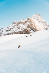  A man on ski alpine tour throught snowy Alps in Switzerland or Austria, Backcountry skier in Alps