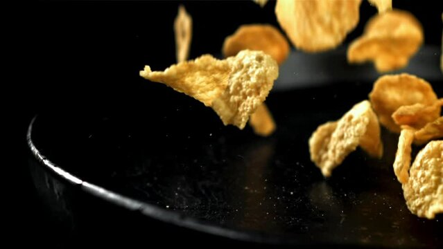 Corn flakes falling on plate. Filmed on a high-speed camera at 1000 fps. High quality FullHD footage