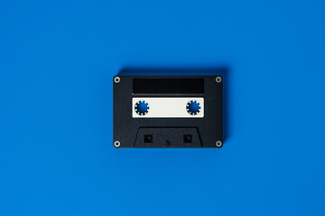 Isolated illustration of a retro cassette tape front panel on a blue background