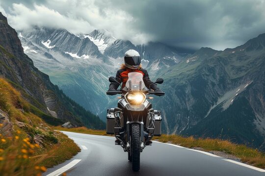 A lone rider braves the winding mountain pass, their trusty motorcycle slicing through the crisp air as they soak in the breathtaking views of the rugged terrain and endless sky above