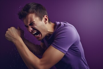 A man is pictured with his arm in the air, as water is gushing out of his mouth. This unique image can be used to convey concepts such as surprise, shock, or even the idea of speaking out