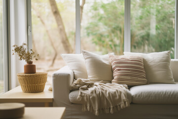 A cozy and stylish living room interior. Couch sofa with linen cushions in pastel neutral colors...