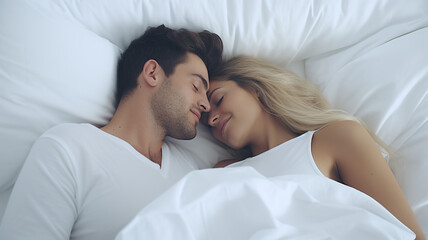 Isolated on a white background, a couple lying in a white bed and showing love.