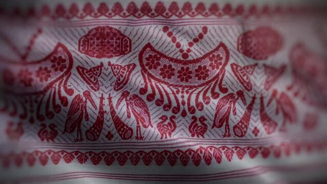 Assamese Gamosa or Gamusa embroidery motifs fabric wave loop. Muga silk cloth fluttering in the wind or waving red and white cloth with a red Indian pattern