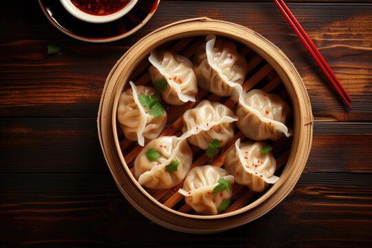 A wooden bowl filled with delicious dumplings, accompanied by a pair of chopsticks. This image is perfect for showcasing Asian cuisine or illustrating a tasty meal