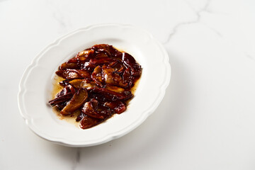 Caramelized apples with spices in white plate. Can be filling for pie or crumble and served over...