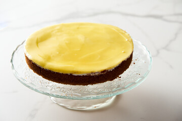 Mascarpone cheesecake with lemon curd and shortbread base. White marble background. High key food photo