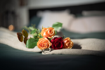 Roses on bed in a hotel room. Background for a romantic valentins day ore mothers day with space...