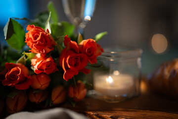 Still life with red roses and candlelight for feelings of love. Romantic background for valentins...