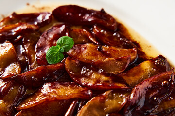 Caramelized apples with spices in white plate. Can be filling for pie or crumble and served over French toasts or pancakes. High key food photo