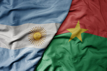 big waving national colorful flag of burkina faso and national flag of argentina .