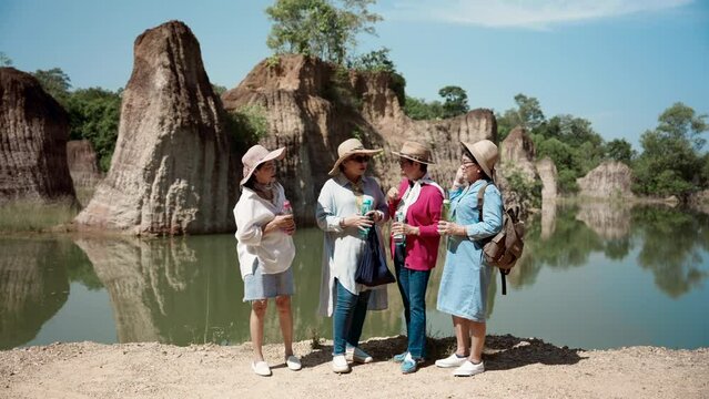 Best friends, group elderly Asian women have been close for long time, make appointment go hiking on nice day, even though, everyone covered themselves up protect themselves from sun.