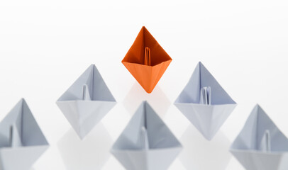 The orange origami boat is leader
