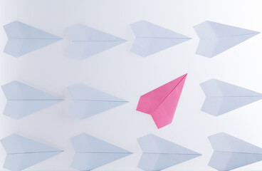Pink origami plane stand out from the crowd