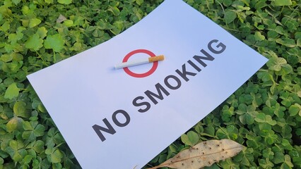 No smoking sign with cigarette on grass in the public park