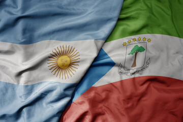 big waving national colorful flag of equatorial guinea and national flag of argentina .