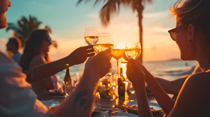 Selbstklebende Fototapeten Beachfront Dinner Toast with Wine Glasses at Sunset © John
