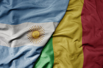 big waving national colorful flag of mali and national flag of argentina .