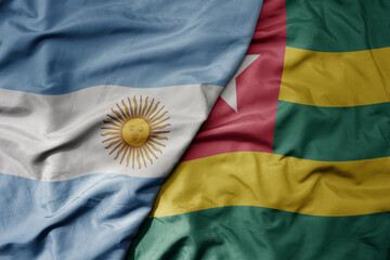 big waving national colorful flag of togo and national flag of argentina .
