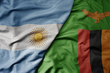big waving national colorful flag of zambia and national flag of argentina .