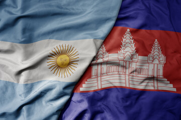 big waving national colorful flag of cambodia and national flag of argentina .