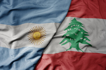 big waving national colorful flag of lebanon and national flag of argentina .