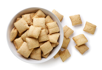 Corn pads in a plate and scattered on a white background. Top view