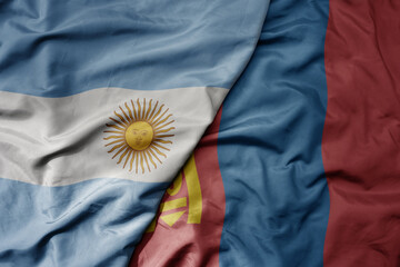 big waving national colorful flag of mongolia and national flag of argentina .