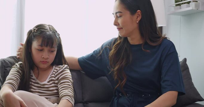 A little daughter is having trouble and her mother is consoling and encouraging her.