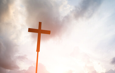 A christian cross under cloudy sky