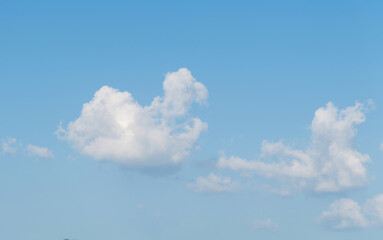 White heart shaped cloud in the blue sky