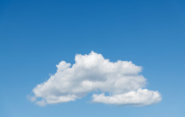 Naklejka na ściany i meble Single white cloud in blue sky