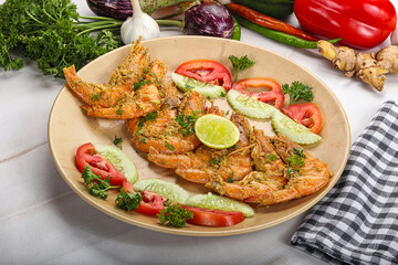 Grilled prawn served lime and vegetables