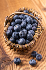 Fresh picked blueberries in a wicker basket - 724834888