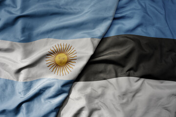 big waving national colorful flag of estonia and national flag of argentina .