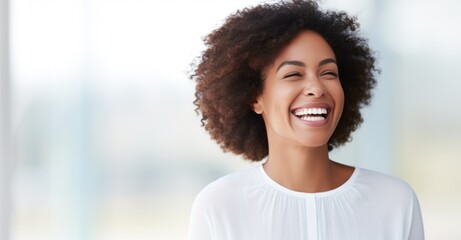 Radiant young woman laughing, ample copy space for positivity.