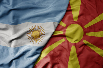 big waving national colorful flag of macedonia and national flag of argentina .