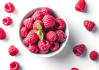 raspberry in a white ceramic bowl, with a few raspberries scattered around the bowl, on a white...