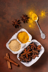 on a rustic background, in a container of eggs, turmeric, ginger powder and star anise. - 724838692