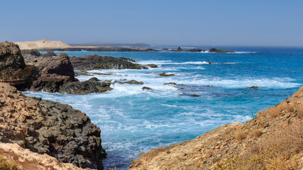 Fototapeta na wymiar Rugged coast of Boa Vista tropical island : rocks and ocean waves. Cape Verde 