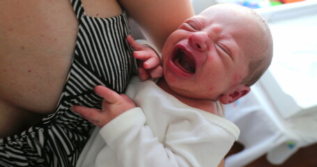 Unhappy newborn baby infant crying