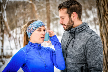 Fitness running woman in winter season with asthma